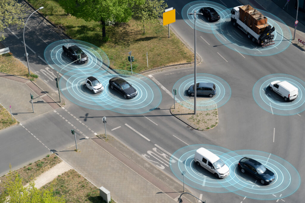 Self driving autonomous cars on multi lane city street. The cars are using radar sensors, wireless communication, GPS and artificial intelligence to navigate and communicate with each other.