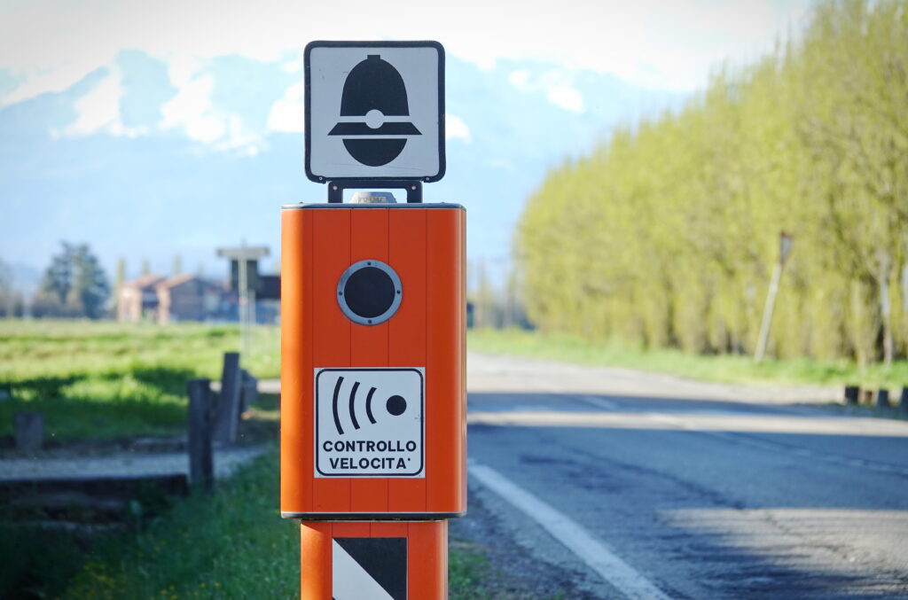 Traffic Enforcement Camera with TEXT that means electronic speed control in italian language and symbol of police